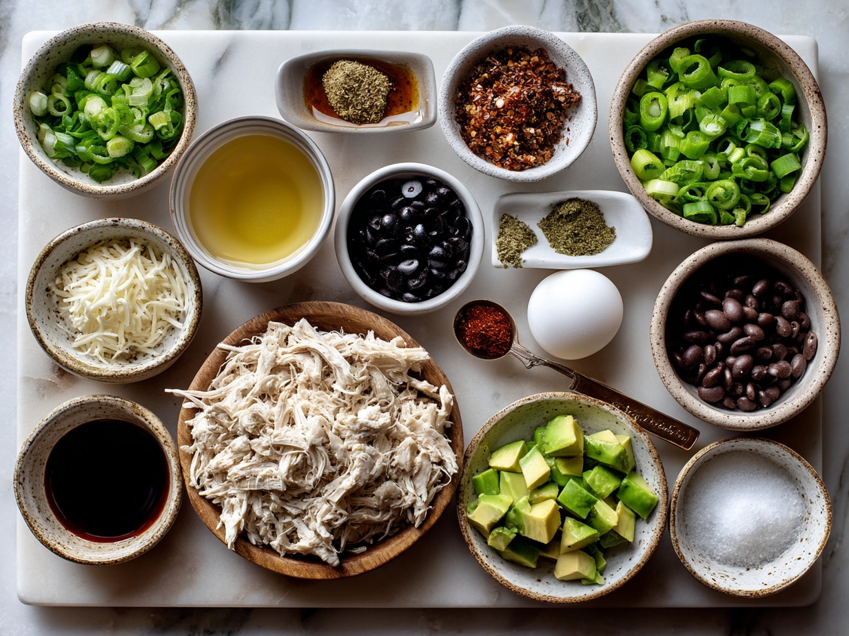Ingredients for Shredded Chicken Enchilada Casserole including shredded chicken, enchilada sauce, tortillas, cheese, onions, green chilies, and spices